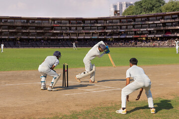 Batsman bowled out after  missing the ball while trying to defend it, while playing a cricket match