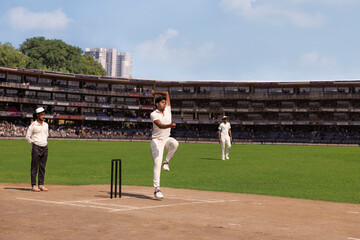 Spin Bowler about to deliver a  ball from the crease,  during a cricket match