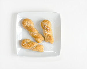 Golden Homemade Twisted Soft Pretzels with Salt on White Plate