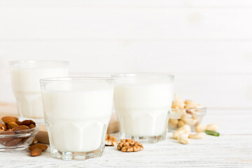 Set or collection of various vegan milk almond, cashew, on table background. Vegan plant based milk and ingredients, top view