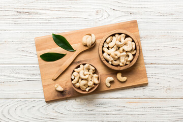 cashew nuts in wooden bowl on table background. top view. Space for text Healthy food