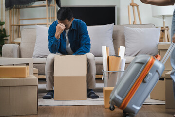 Unhappy young couple sitting apart, having problems in relationship, thinking of breaking up or...