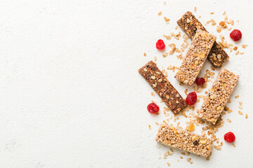 Various granola bars on table background. Cereal granola bars. Superfood breakfast bars with oats, nuts and berries, close up. Superfood concept