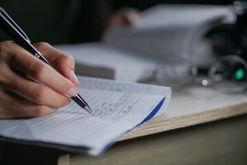 Closeup of girl writing on her journal