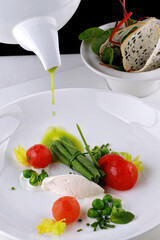 Cream soup of green peas with tomatoes, on a white background