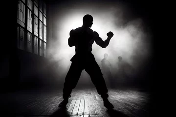 Fotobehang shadowy silhouette of boxer prepares to execute the punch © Emma