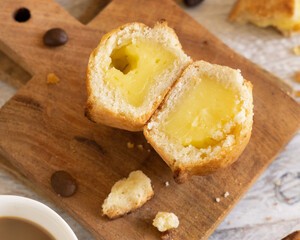 Pasticciotto leccese pastry filled with egg custard cream on a wood close up