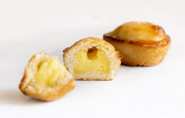Pasticciotto leccese pastry filled with egg custard cream on a white table, close up
