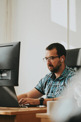 Portrait professional man programmer working concentrated on computer in diverse offices. Modern IT...