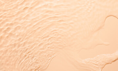 Water beige surface abstract background. Waves and ripples texture of cosmetic aqua moisturizer with bubbles.