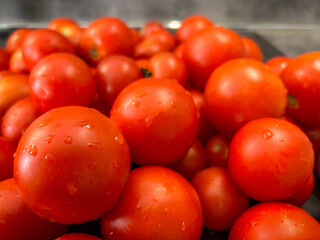 Close-up photo of pile of ripe red washed tomatoes
