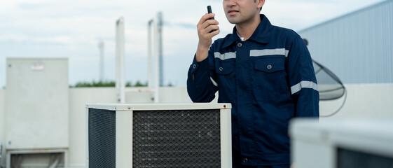 Asian maintenance engineer work on the roof of factory. contractor inspect compressor system and...