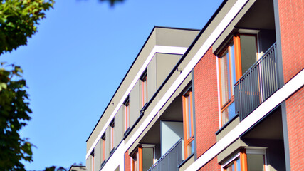 Obraz premium Brand new apartment building on sunny day. Modern residential architecture. Modern multi-family apartment house. 