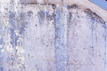 Cement wall with paint and stains due to humidity