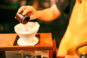 People use coffee making equipment and tools at home kitchens to brew hot coffee that drips into their cups, Professional barista preparing coffee over coffee maker and drip kettle