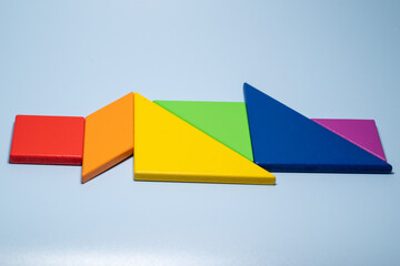 Close-up of the colorful tangram on blue background,LGBTQ(LGBTQ+) community flag colour,rainbow colours