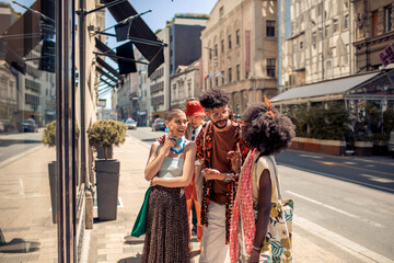 Young and diverse group of friends checking out stores and shopping while on vacation in the city