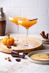 Halloween, Thanksgiving or fall cocktail pumpkin martini, homemade festive seasonal drink pumpkintini with cinnamon