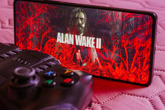 October 9, 2023, Brazil. In this photo illustration, the Alan Wake 2 logo is displayed on a smartphone screen, next to a gamepad.