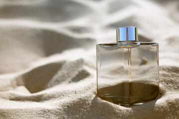 bottle of Perfume on the beach against the background of the sea