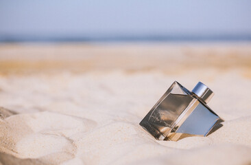 Bottle of perfume on the beach
