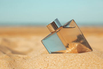 bottle of perfume on the sand