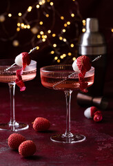 Lychee cocktail with fresh fruits. Christmas lights on the background