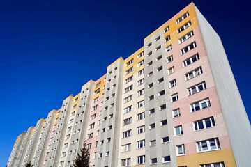 facade of a modern multi-storey residential building with balconies and windows in the city of Poznan