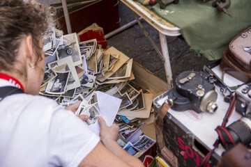 Hands of a woman, looking at old family photos