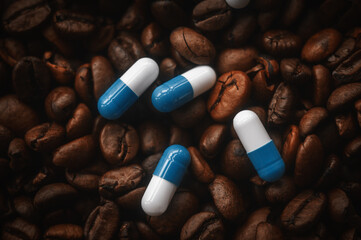 Caffeine tablets on a background of coffee beans. Medicinal properties of coffee. Pills on a background of coffee close-up.