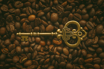 Old vintage key on a background of coffee beans.
Coffee drink is the key to a successful day.