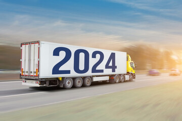 Long truck trailer with the inscription 2024 new year, the truck rushes along the road during a...