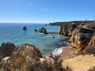 Ponta da Piedade in Lagos Portugal showing coastal rock formations with caves & grottos by the ocean coast on a clear day perfect for a hike