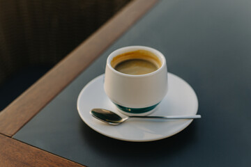 Cup of black coffee on a table in a cafe.