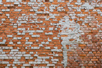 Vintage damaged red brick wall.
