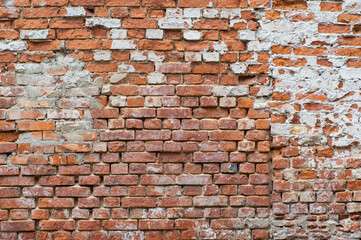 Vintage damaged red brick wall.