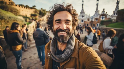 Stoff pro Meter Tourists take selfies with smartphones in Park Guell, Barcelona, Spain - Man smiling on vacation © sirisakboakaew