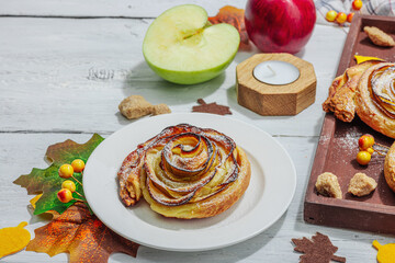 Apple roses pie with sugar powder. Traditional autumn baking, fall decor, flat lay