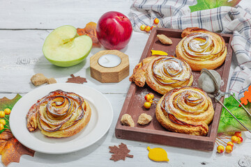 Apple roses pie with sugar powder. Traditional autumn baking, fall decor, flat lay