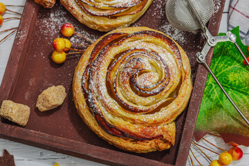 Apple roses pie with sugar powder. Traditional autumn baking, fall decor, flat lay
