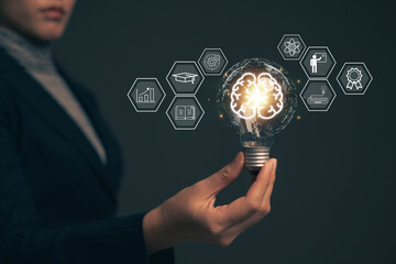 E-learning graduate certificate program concept.Woman holds a light bulb showing a brain icon....