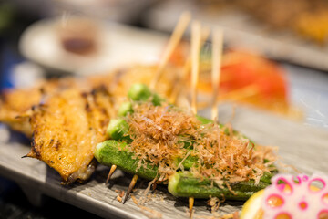 Skewers with chicken wing and okra in restaurant