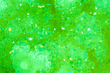 Green crystal mineral stone. Gems. Mineral crystals in the natural environment. Texture of precious...
