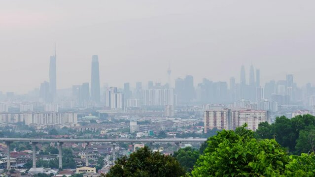 4k Time lapse of Kuala lumpur city center klcc with many highrise building skyscrapers in financial distict center area with snog smoke air pollution pm2.5 in the air