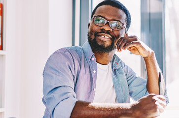 Positive man creating ideas for writing in exercise book