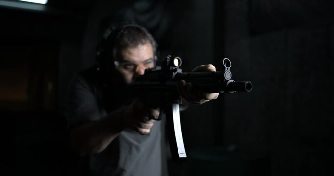 Front view of Person Aiming and Firing HK SP5K, High-Speed German Assault Rifle Shooting