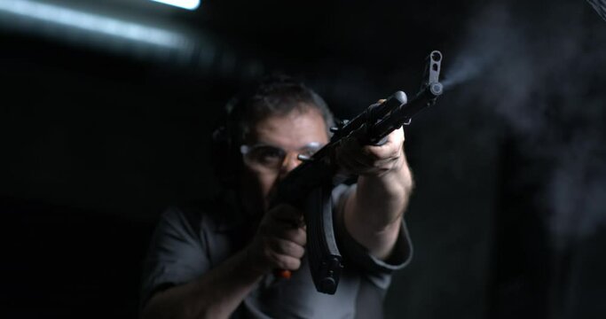 High-Speed 800fps Slow-Motion Shooting with AK-47, Man Aiming and Firing Kalashnikov Rifle, low-angle shot