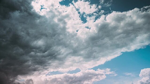 Timelapse Dark Blue Cloudy Rainy Sky. Rain Heavy Clouds Give Way To White Fluffy Clouds. Sky Natural Background. Cumulonimbus Cloud. Weather Forecast Concept. Enlightenment Concept. From Dark To Light