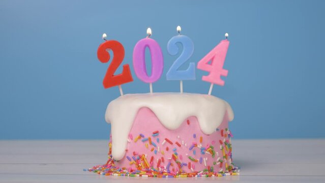 Happy New Year 2024, seamless looping of cute cake with colorful candle number 2024 for new year celebrate party was lit. flame at candlewick sway and flicker with blue background, horizontal 