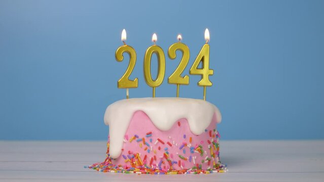 Happy New Year 2024, seamless looping of cute cake with golden candle number 2024 for new year celebrate party was lit. flame at candlewick sway and flicker with blue background, horizontal 